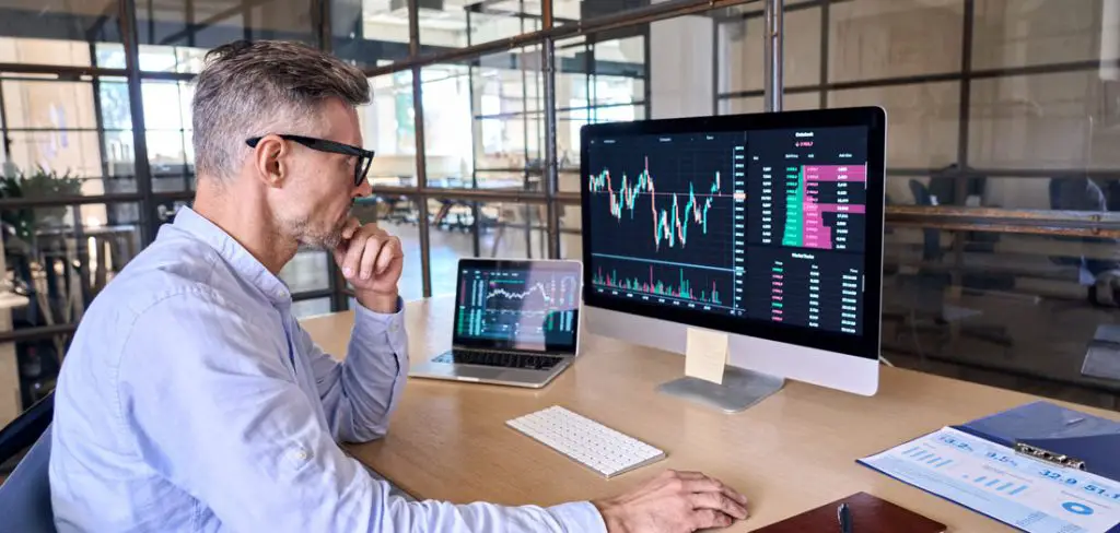 Stock trader at table with computer.